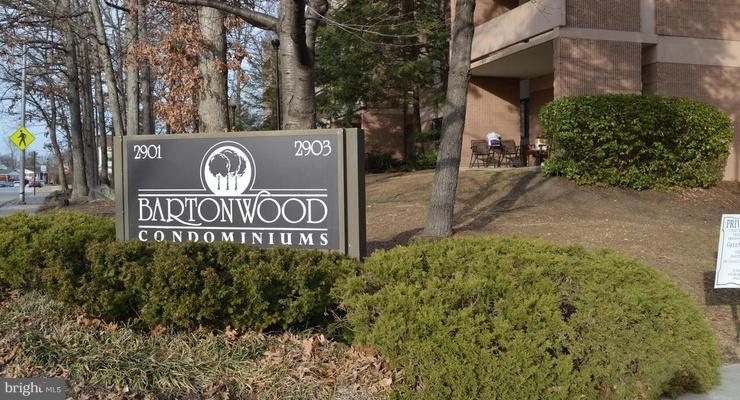 2901 Fallstaff Road, Unit 505 Baltimore, MD 21209 - Photo 1 of 15 a sign broad in front of a red brick house