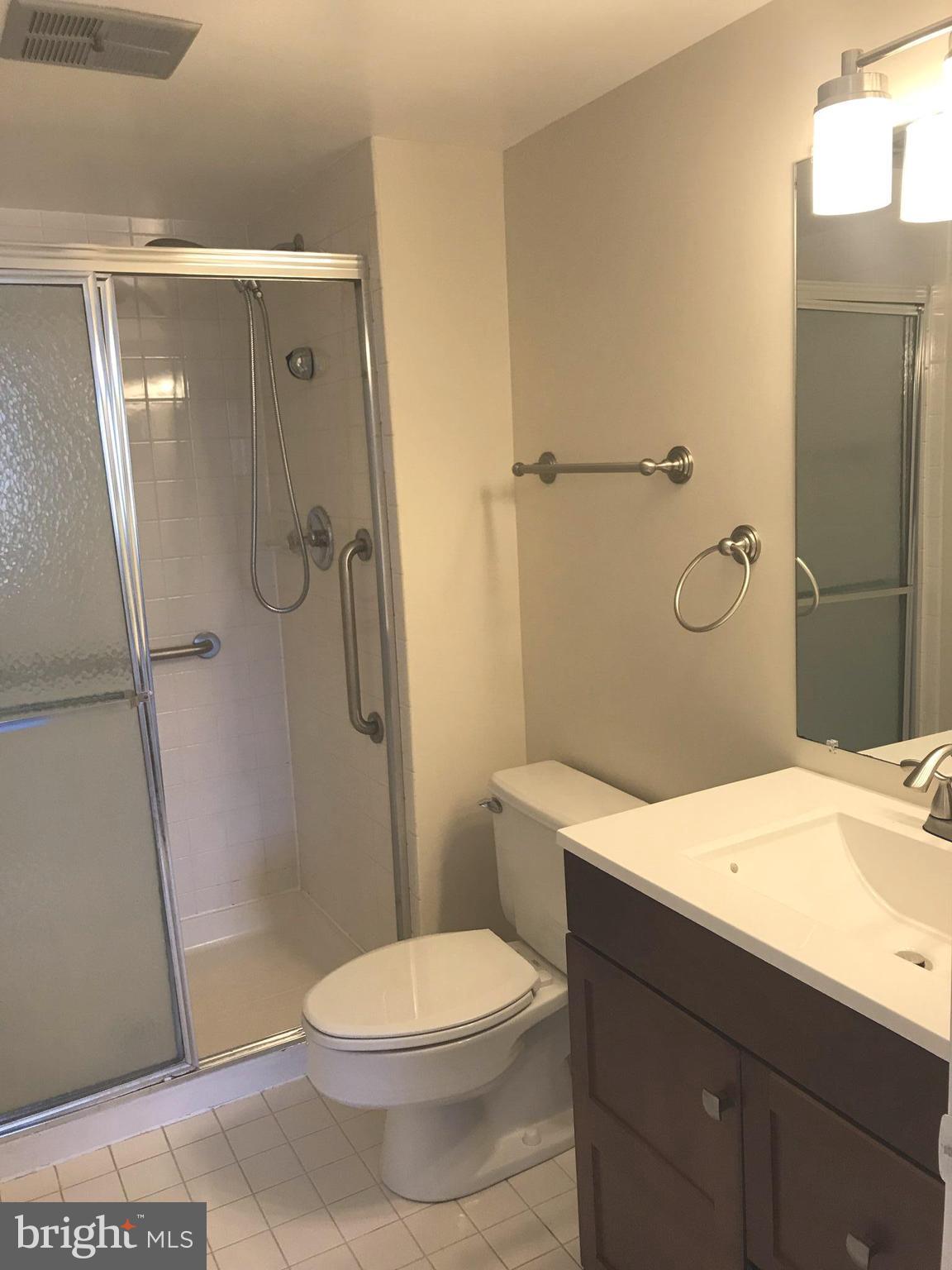 2901 Fallstaff Road, Unit 505 Baltimore, MD 21209 - Photo 14 of 15 a bathroom with a sink a toilet and shower
