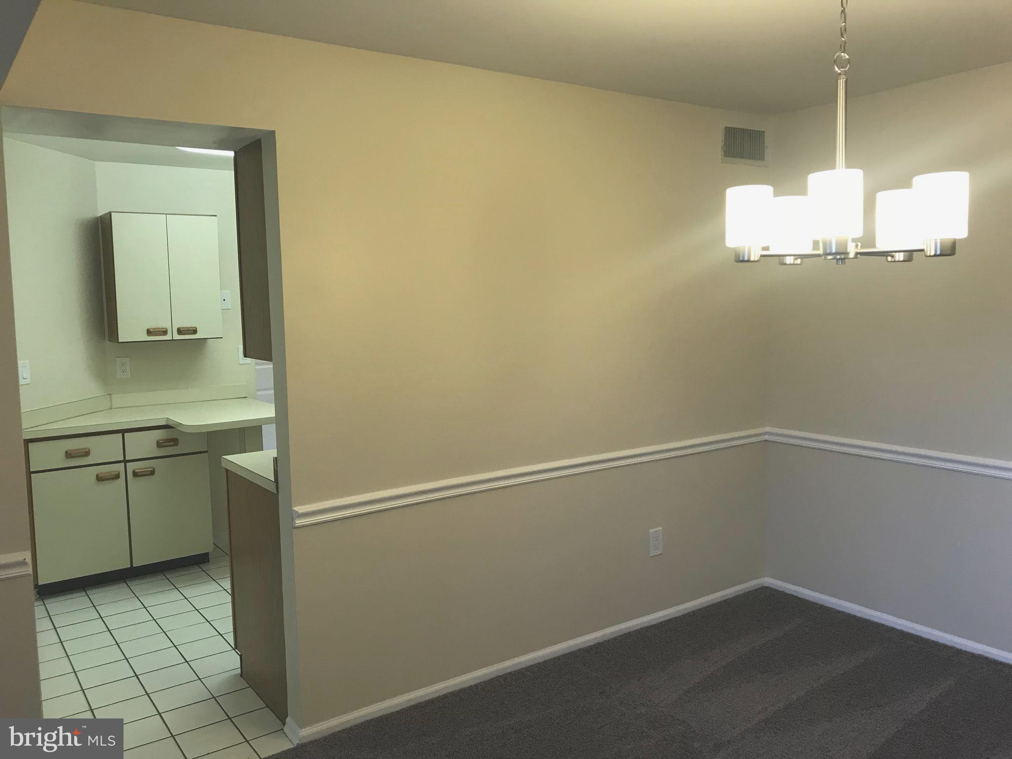 2901 Fallstaff Road, Unit 505 Baltimore, MD 21209 - Photo 4 of 15 a room with cabinets and wooden floor