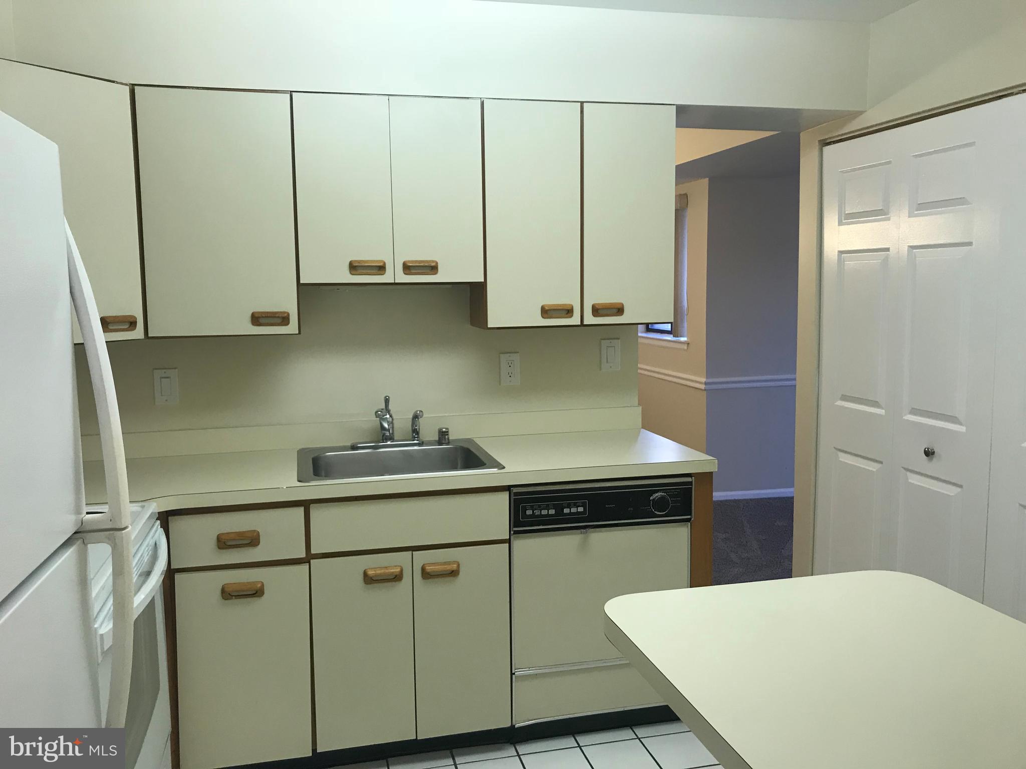 2901 Fallstaff Road, Unit 505 Baltimore, MD 21209 - Photo 5 of 15 a kitchen with a sink a stove and cabinets