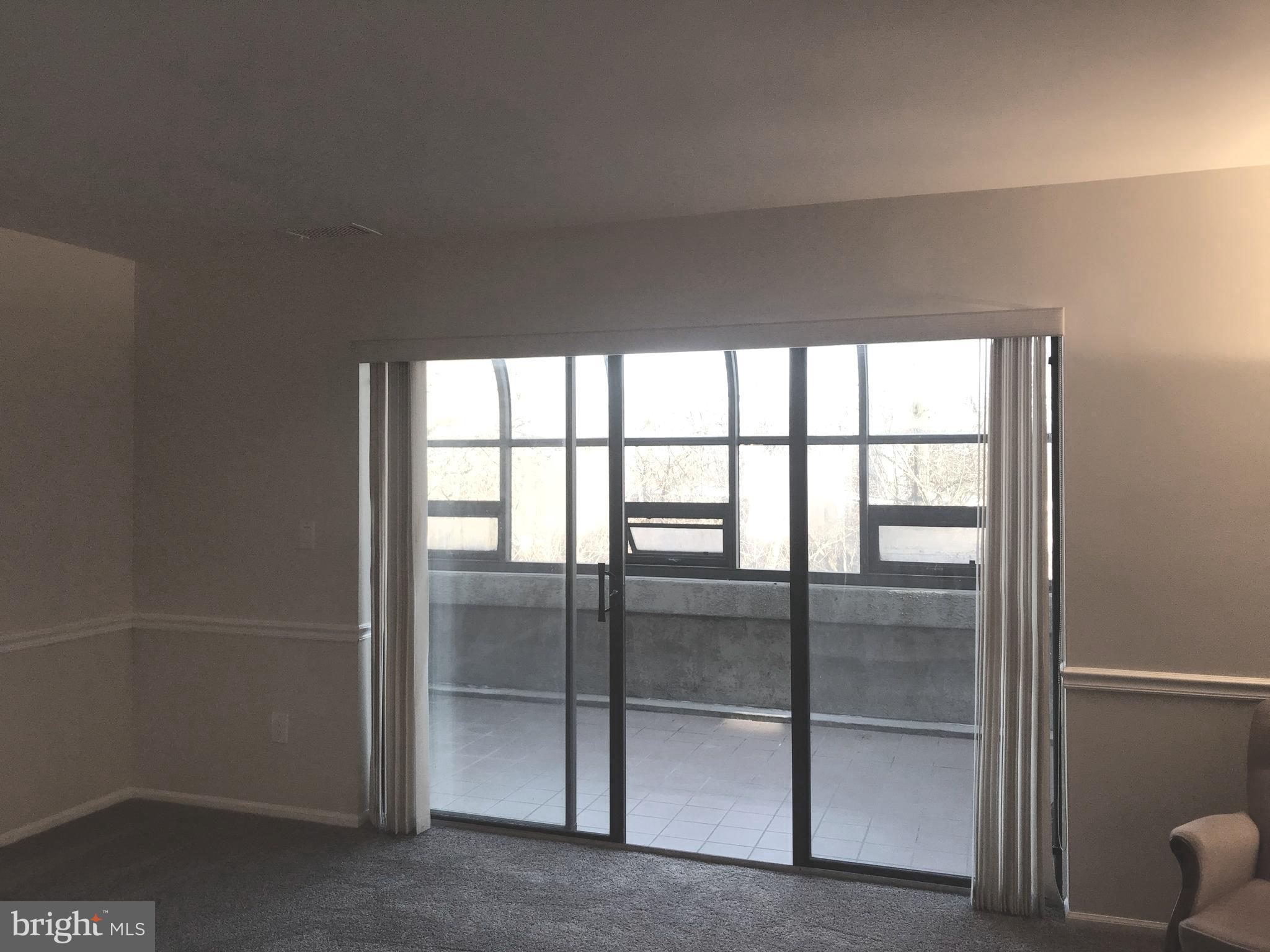2901 Fallstaff Road, Unit 505 Baltimore, MD 21209 - Photo 9 of 15 a view of empty room with sliding window