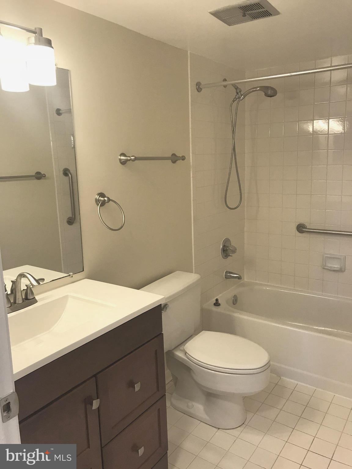 2901 Fallstaff Road, Unit 505 Baltimore, MD 21209 - Photo 10 of 15 a bathroom with a sink a toilet and shower