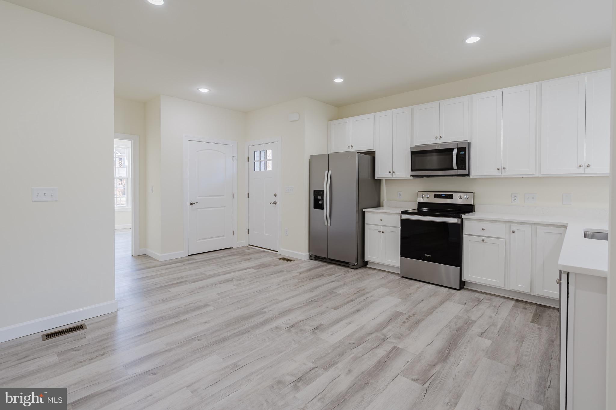 51 Mapledale Road Dover, DE 19904 - Photo 14 of 53 a view of kitchen with stainless steel appliances refrigerator stove microwave and cabinets