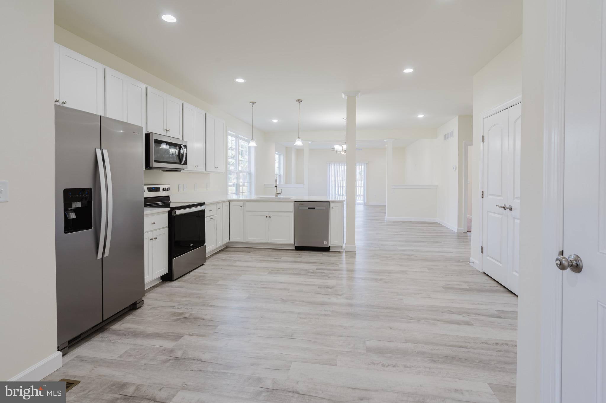 51 Mapledale Road Dover, DE 19904 - Photo 17 of 53 a view of kitchen with refrigerator microwave and stove
