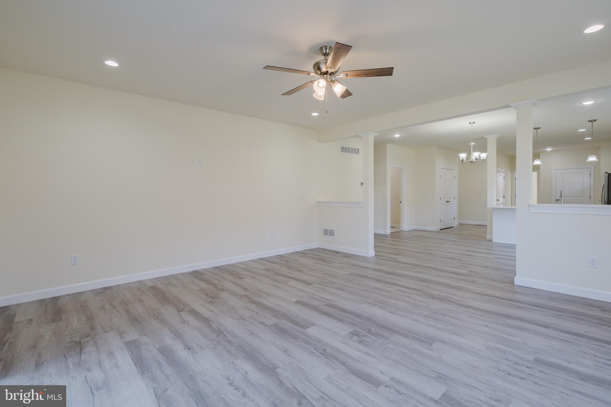 51 Mapledale Road Dover, DE 19904 - Photo 23 of 53 a view of an empty room with wooden floor and a ceiling fan