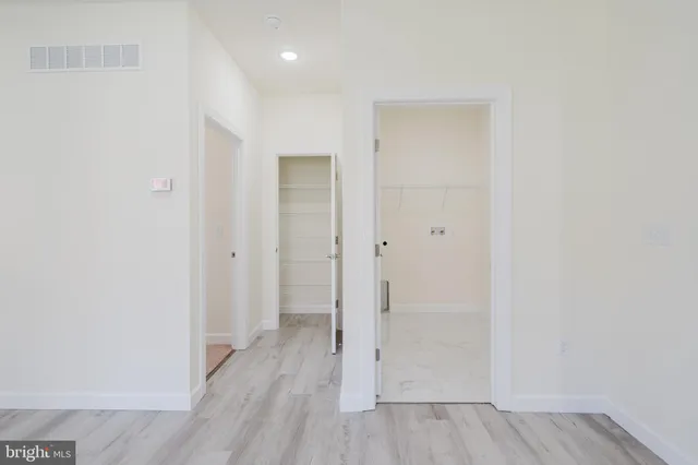 a spacious bathroom with a toilet sink and mirror