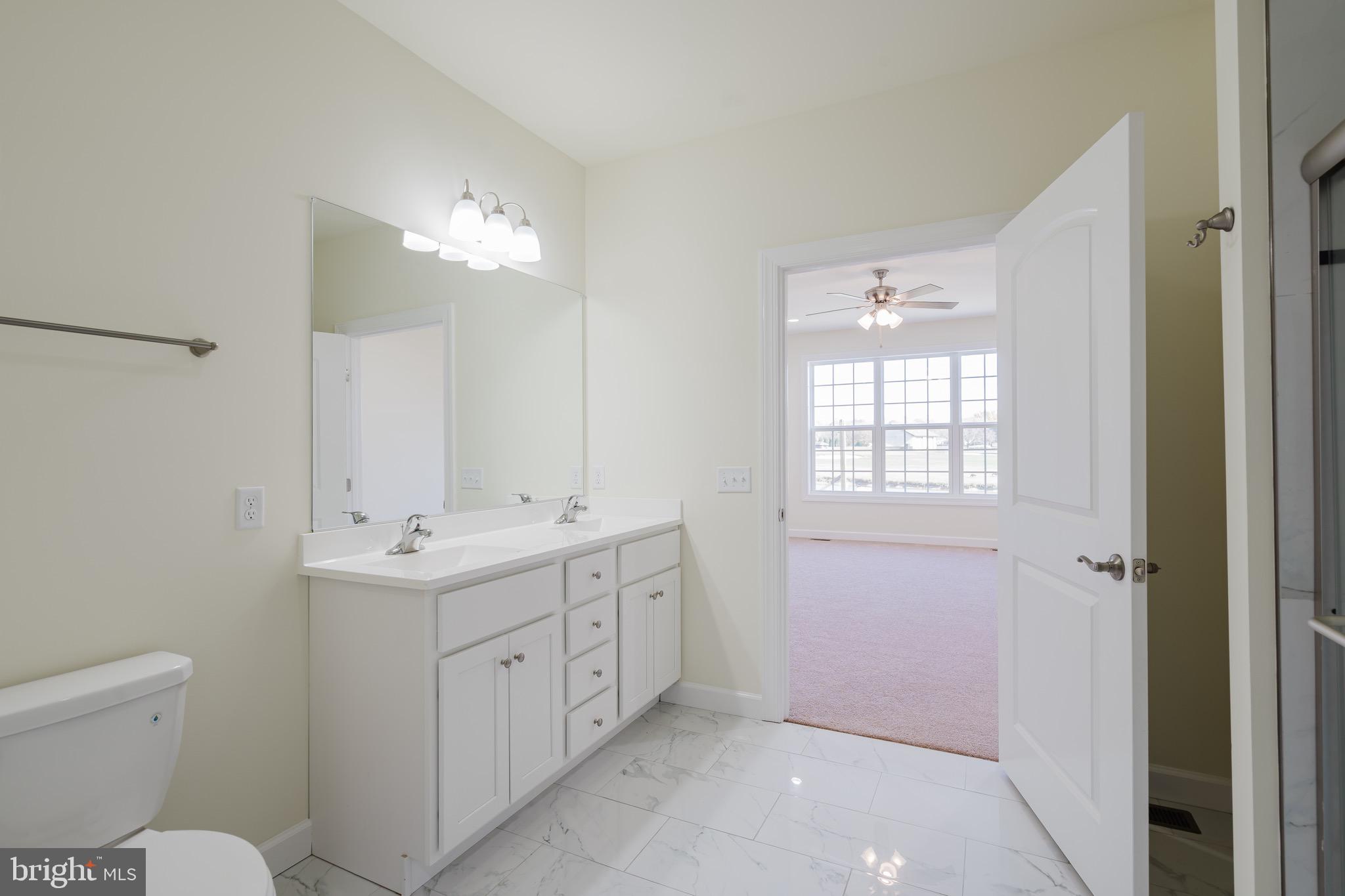 51 Mapledale Road Dover, DE 19904 - Photo 43 of 53 a spacious bathroom with a toilet sink and mirror