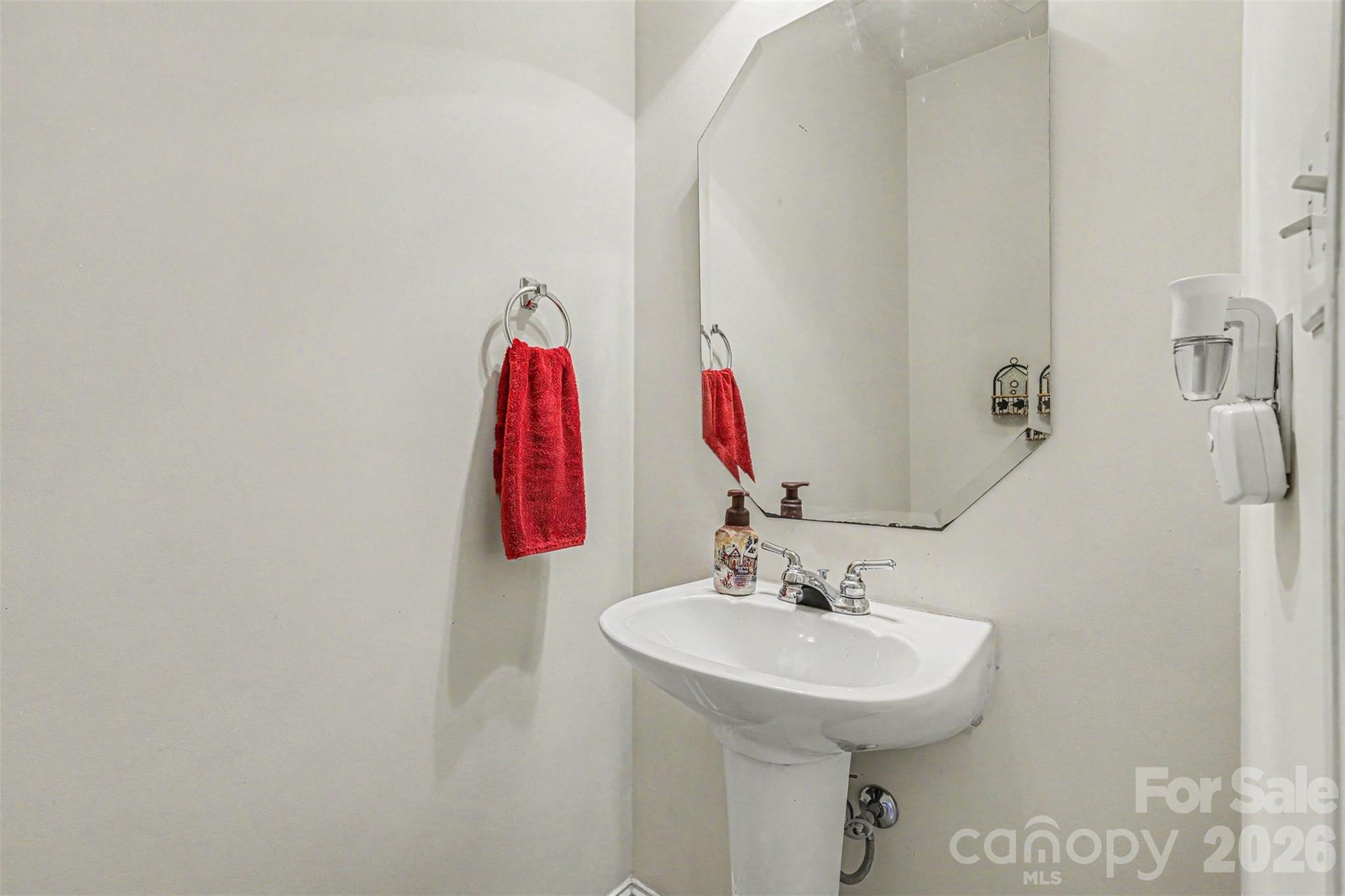 3035 Proverbs Court Monroe, NC 28110 - Photo 12 of 30 a bathroom with a sink and a mirror
