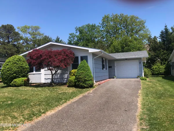 a front view of house with yard and trees