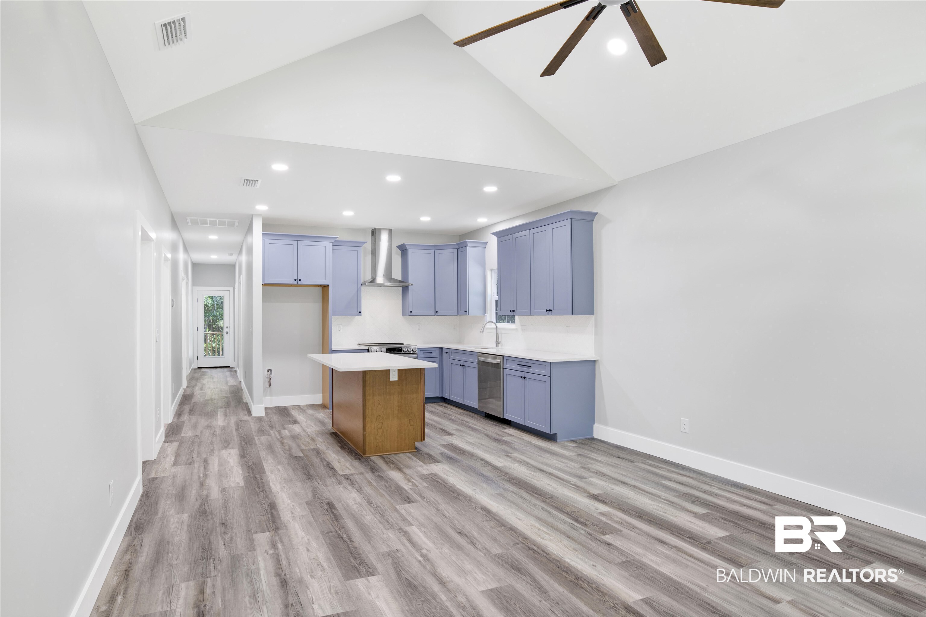 30604 Orange Street Elberta, AL 36530 - Photo 5 of 27 Kitchen with wall chimney range hood, ceiling fan, light hardwood / wood-style floors, dishwasher, and a center island