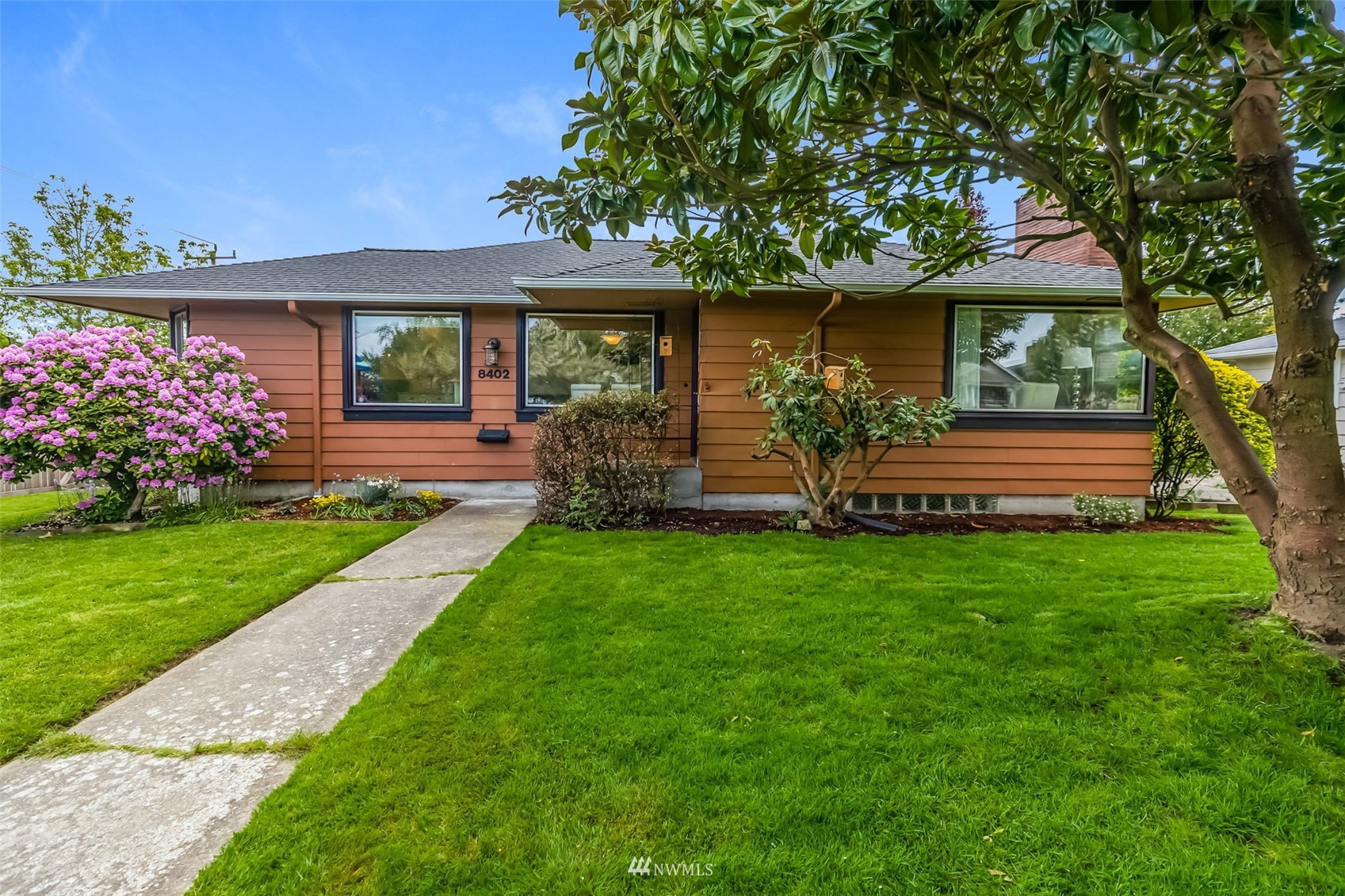 a front view of a house with garden