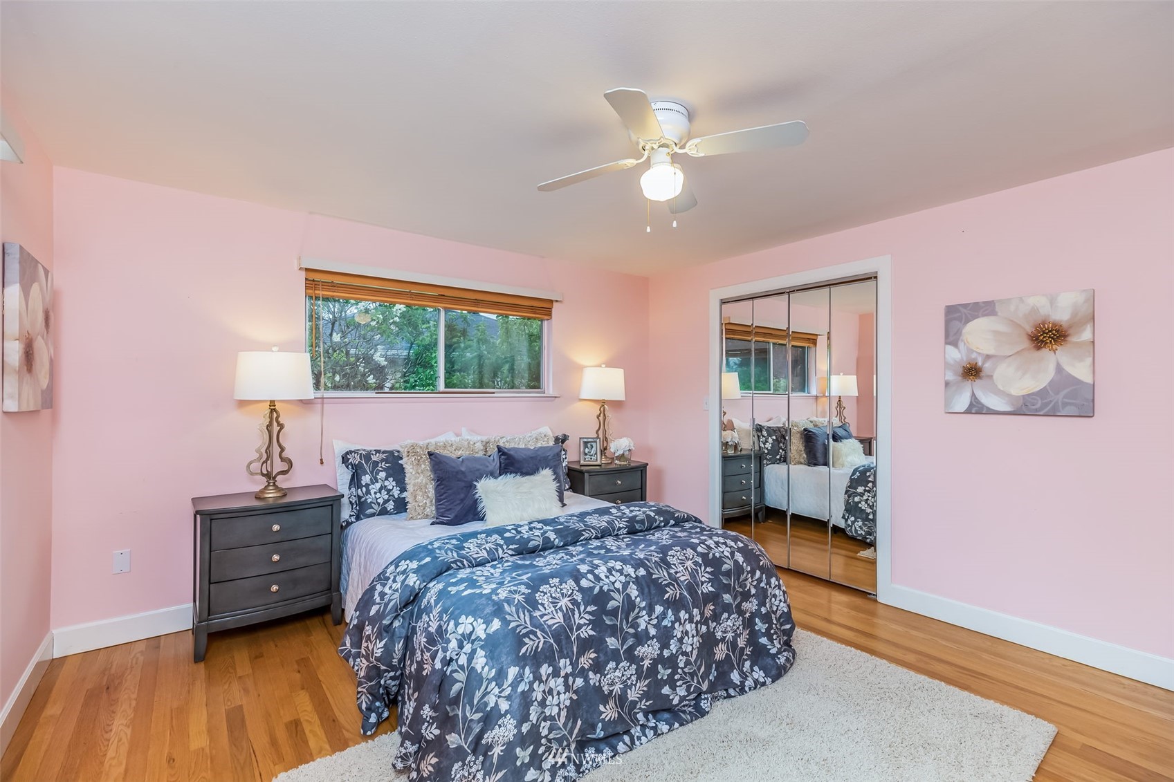 8402 13th Avenue Southwest Seattle, WA 98106 - Photo 17 of 40 a bedroom with a large bed and a chandelier