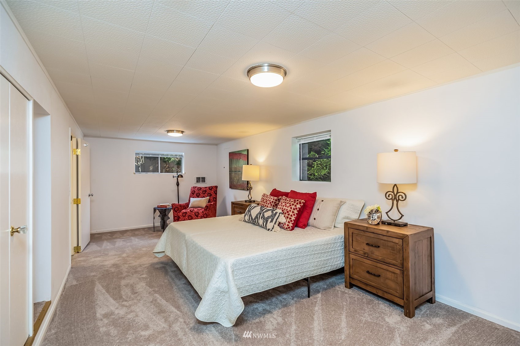 8402 13th Avenue Southwest Seattle, WA 98106 - Photo 24 of 40 a bedroom with a bed and a chandelier