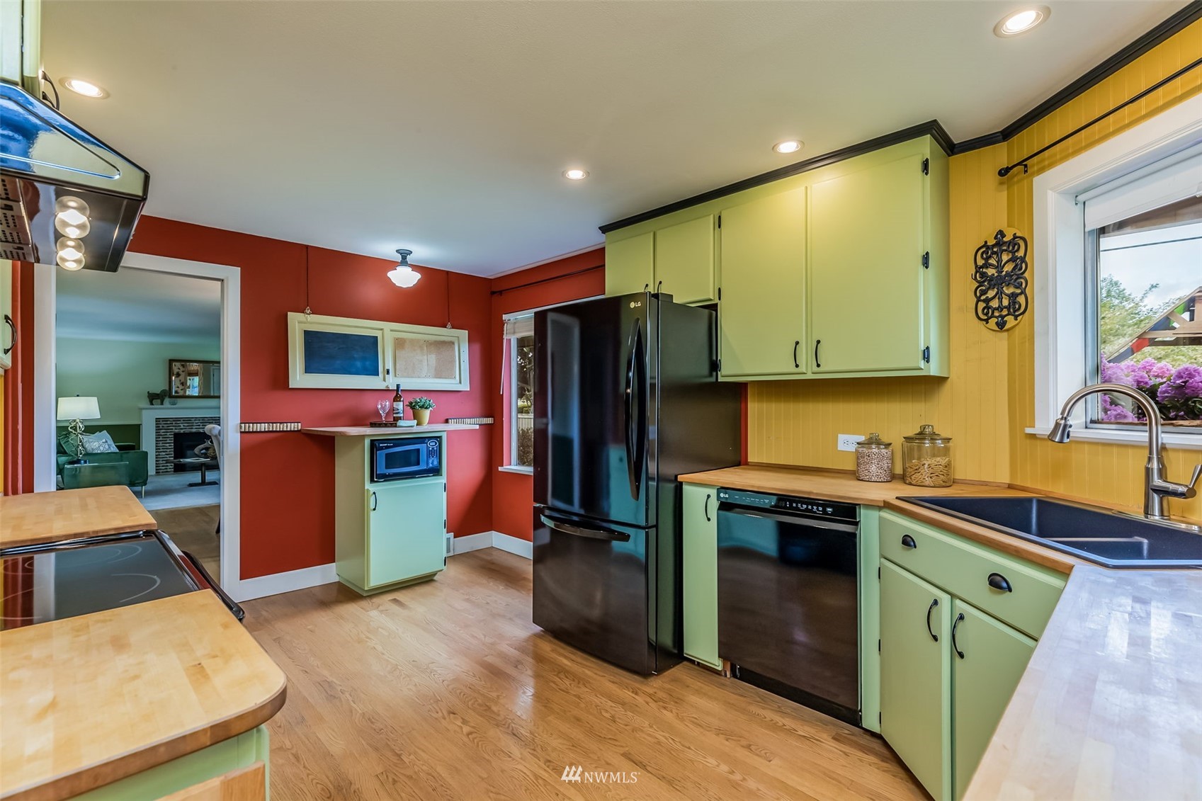 8402 13th Avenue Southwest Seattle, WA 98106 - Photo 10 of 40 a kitchen with stainless steel appliances a sink stove and refrigerator