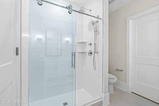 a bathroom with a shower and a glass door