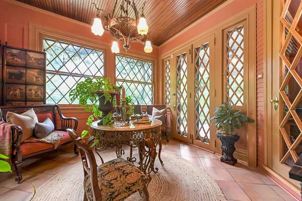 a dining room with furniture a chandelier and a rug
