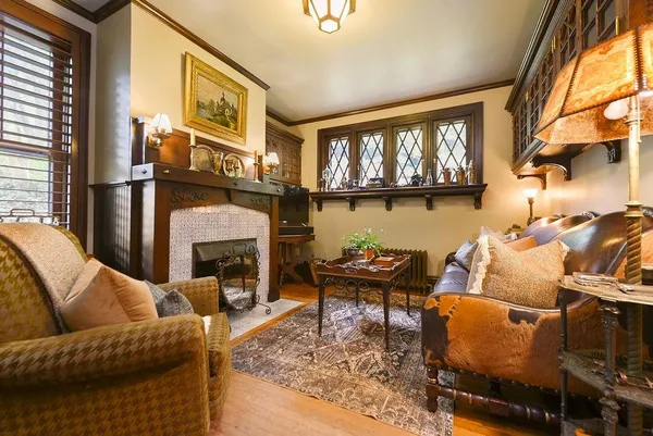 a living room with furniture fireplace and a window