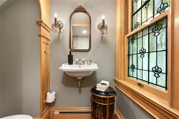 a bathroom with a sink a toilet and a mirror