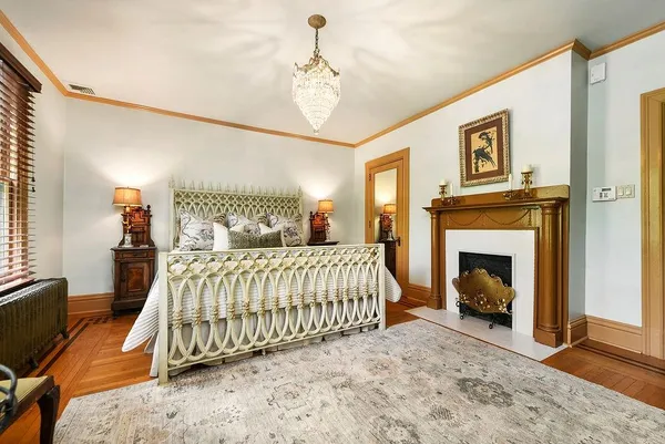 a bedroom with a bed and a fireplace