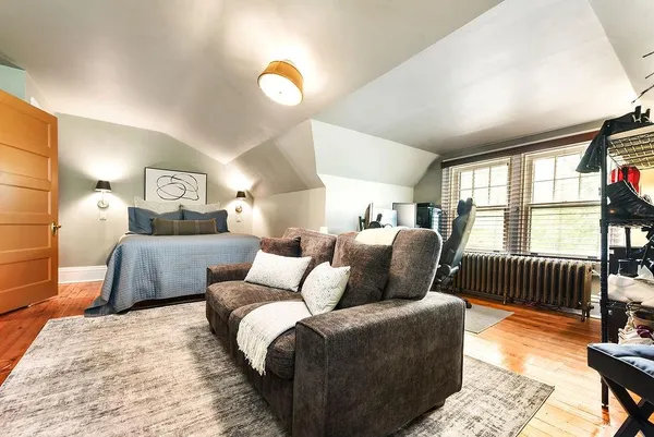 a bedroom with furniture and wooden floor