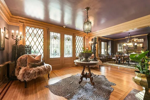 a living room with fireplace furniture and a large window