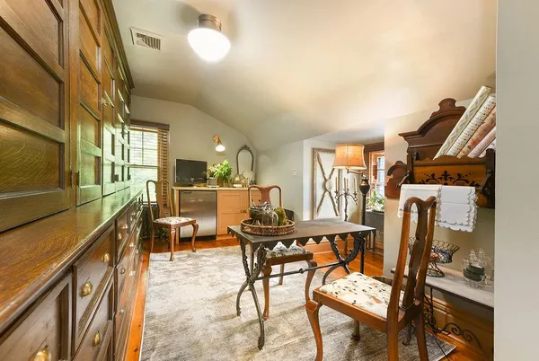 a living room with furniture a fireplace and a large window