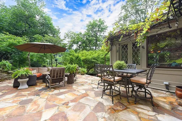a view of a chair and table in backyard of the house