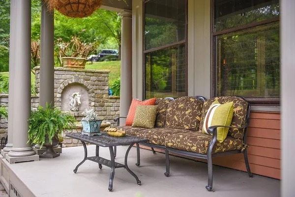 a view of a house with sitting area and garden