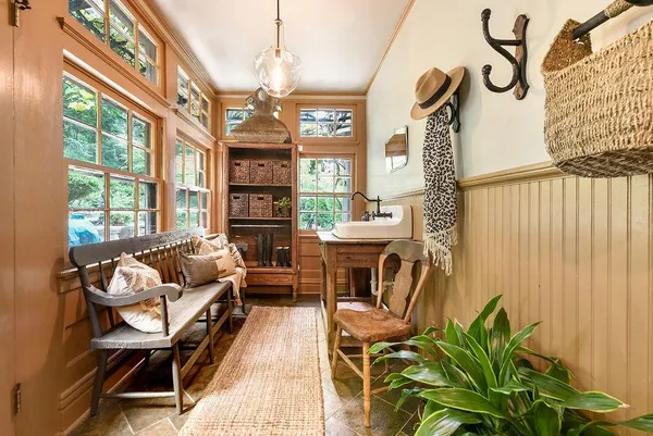 a living room with furniture a fireplace and a chandelier