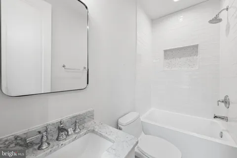 a bathroom with a sink toilet and bathtub