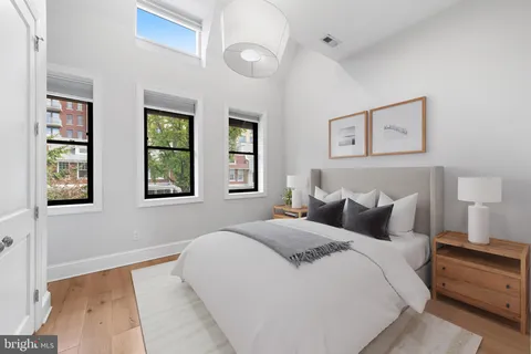 a bedroom with a large bed and a window