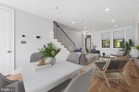 a living room with furniture potted plant and hallway