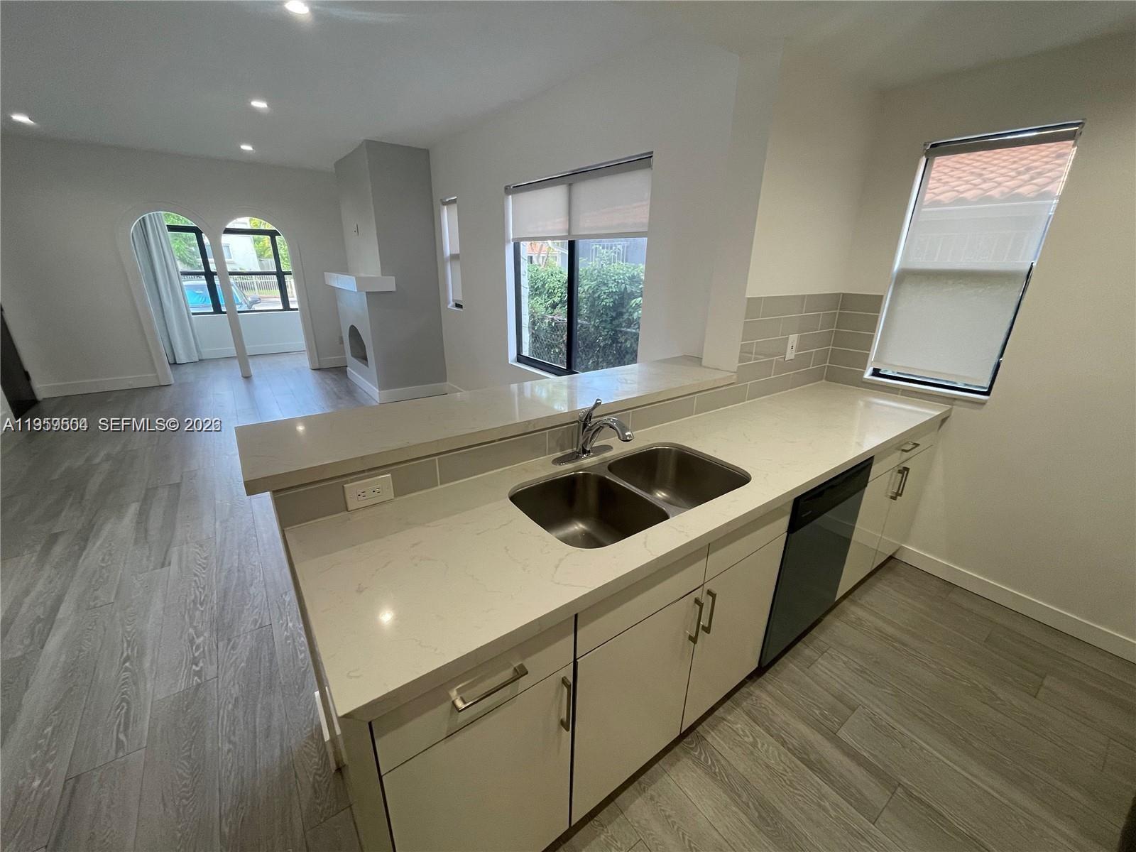 1637 Southwest 10th Street, Unit 2 Miami, FL 33135 - Photo 3 of 9 a kitchen that has a sink and a stove top oven