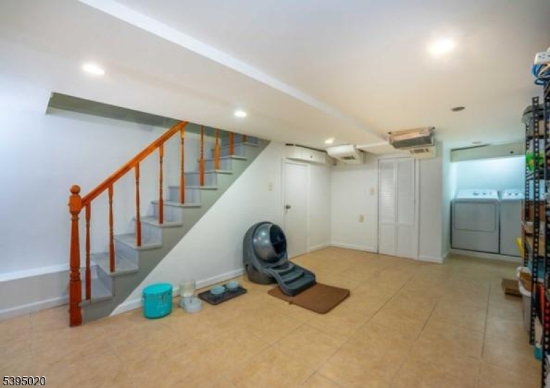220 North 17th Street Bloomfield, NJ 07003 - Photo 15 of 19 a view of a livingroom with wooden floor and stairs