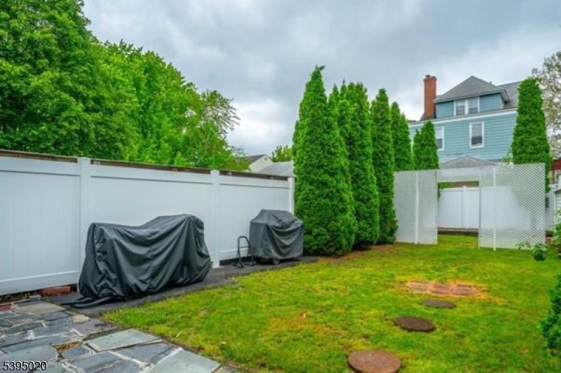 220 North 17th Street Bloomfield, NJ 07003 - Photo 18 of 19 a view of a backyard with potted plants and a large tree
