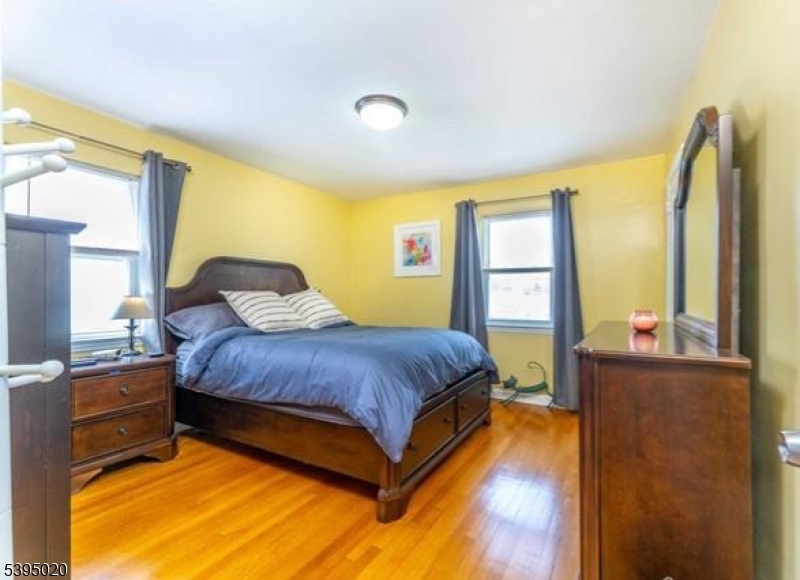 220 North 17th Street Bloomfield, NJ 07003 - Photo 7 of 19 a bedroom with a bed and wooden floor