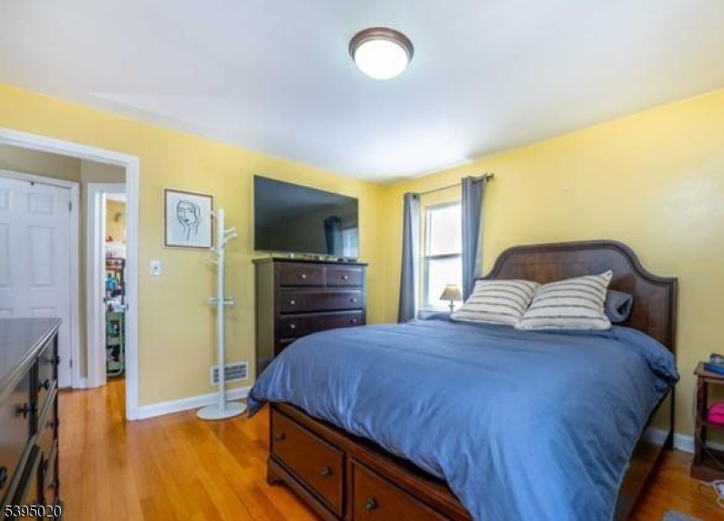 220 North 17th Street Bloomfield, NJ 07003 - Photo 8 of 19 a bedroom with a bed and a flat screen tv