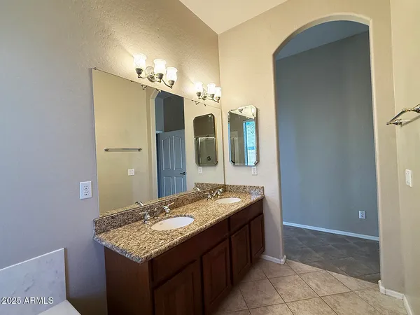 an empty room with windows and fireplace