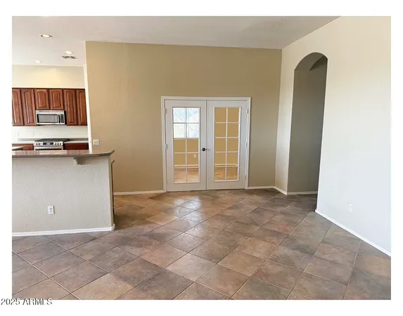 a kitchen with kitchen island a counter top space cabinets and stainless steel appliances