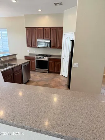a kitchen with a sink a stove a microwave and cabinets