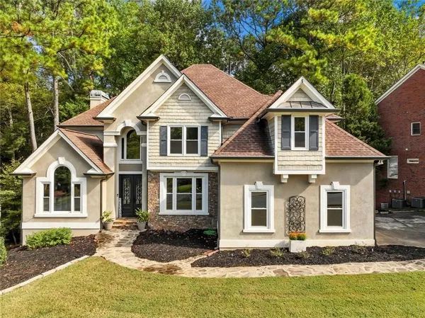 a front view of a house with a yard