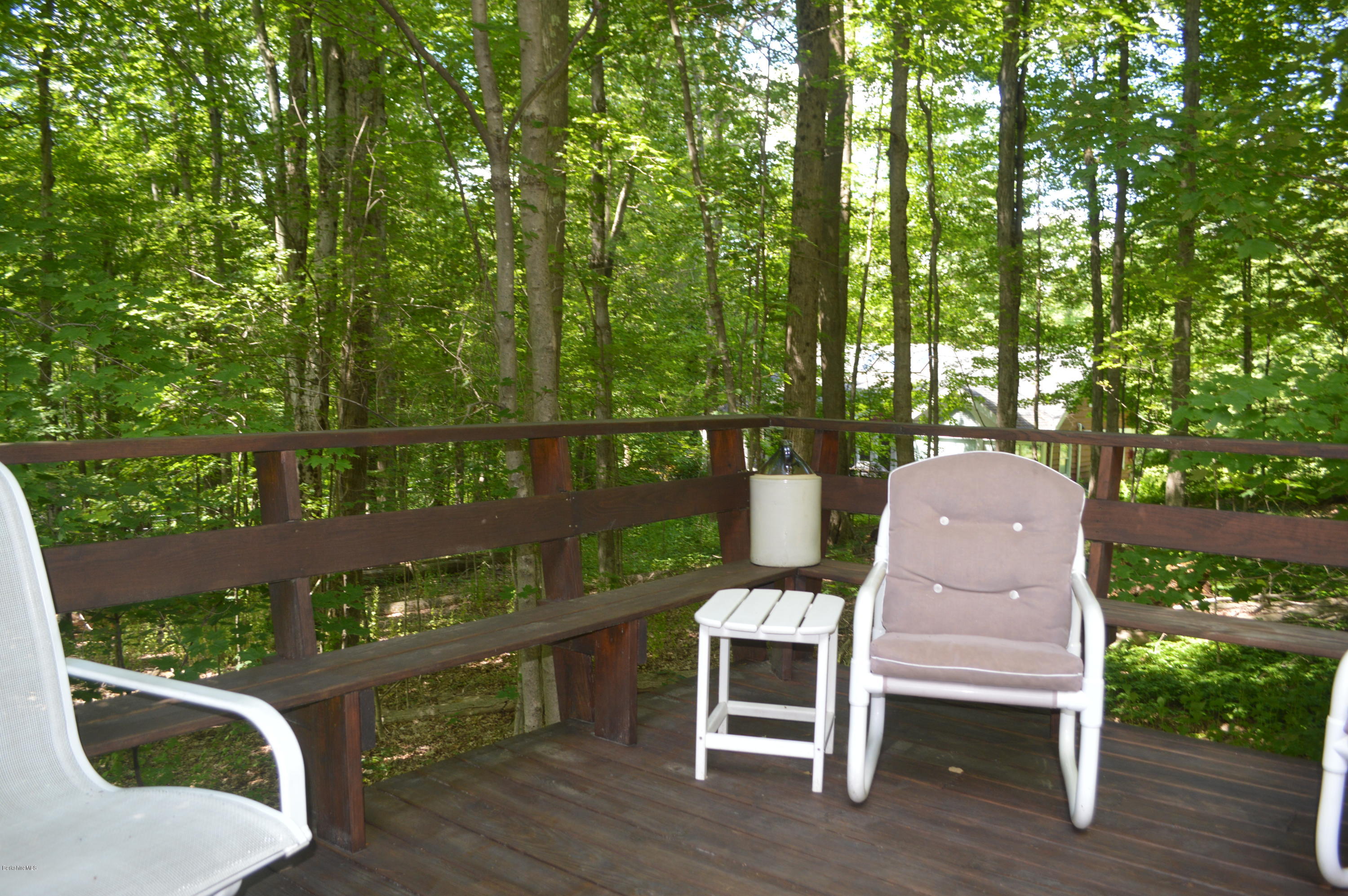 2 Massasoit Road Stockbridge, MA 01262 - Photo 23 of 31 a wooden bench sitting in the middle of a lake