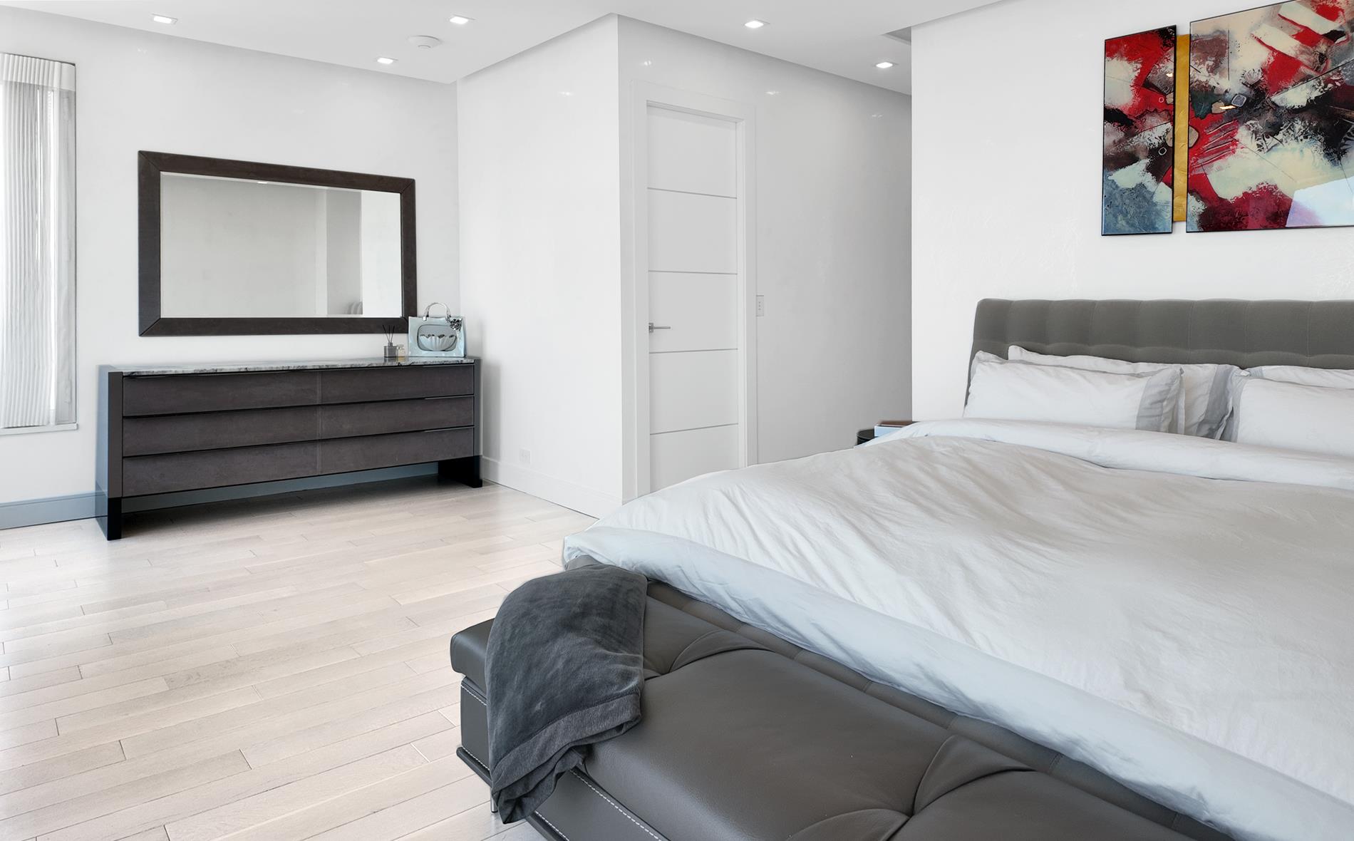 200 East 69th Street, Unit 31A Manhattan, NY 10021 - Photo 10 of 19 a bedroom with a bed and a painting on the wall