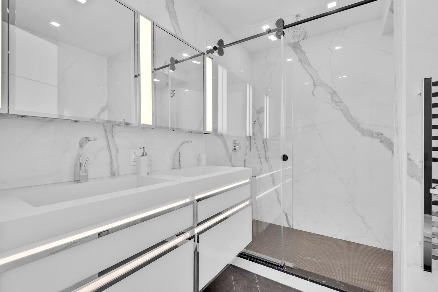 200 East 69th Street, Unit 31A Manhattan, NY 10021 - Photo 16 of 19 a view of a bathroom with a sink and a shower