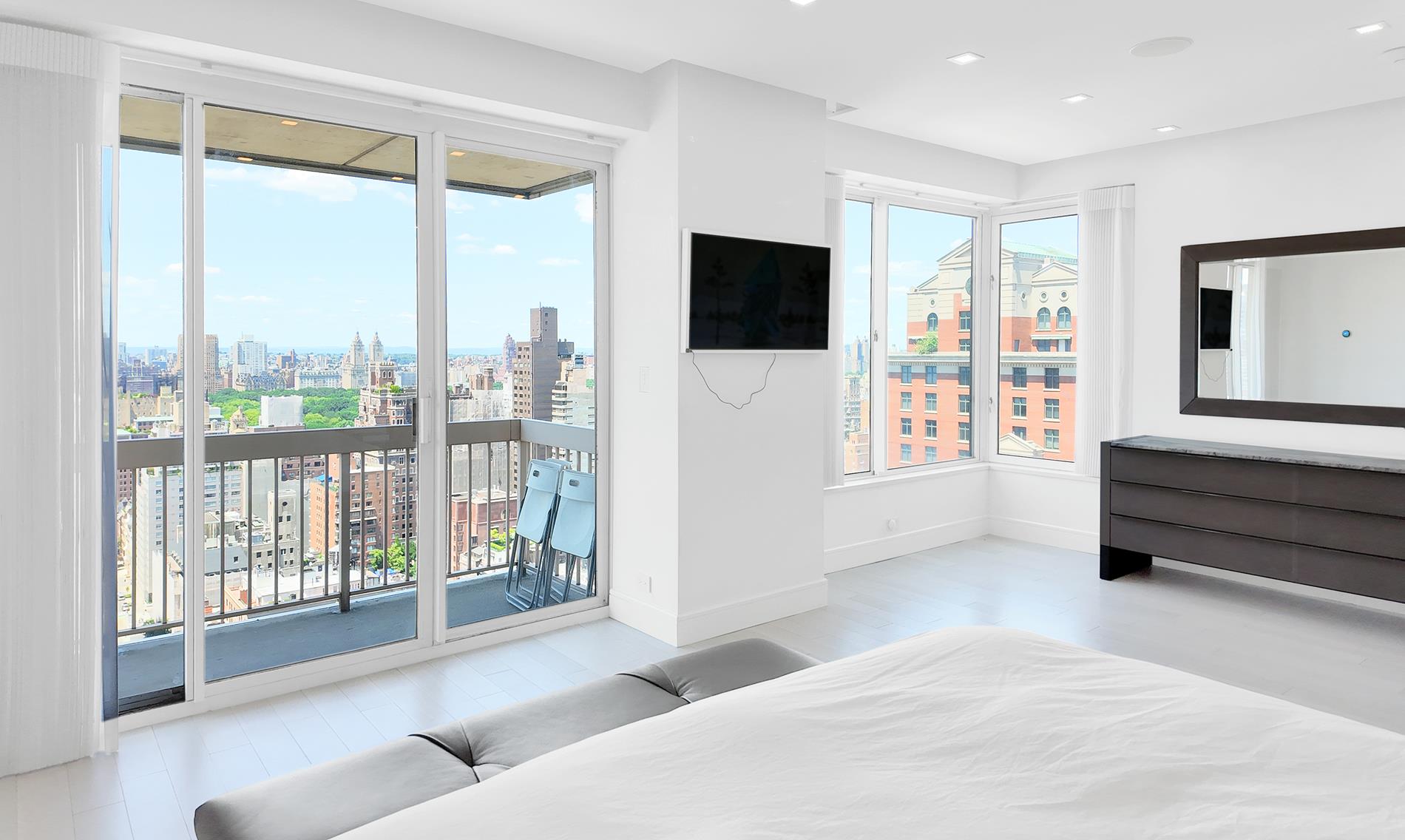 200 East 69th Street, Unit 31A Manhattan, NY 10021 - Photo 9 of 19 a living room with furniture and a flat screen tv