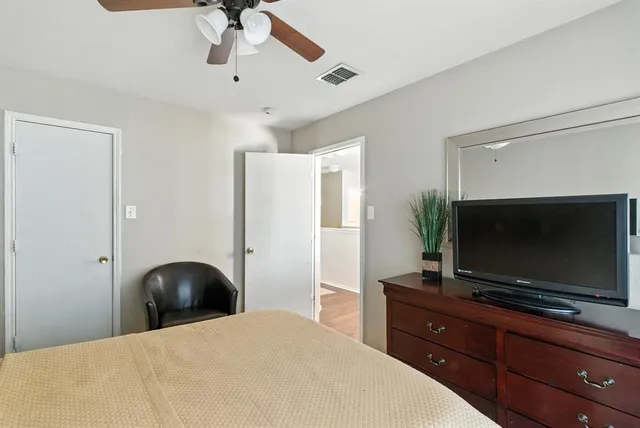 a bedroom with a bed and a flat screen tv