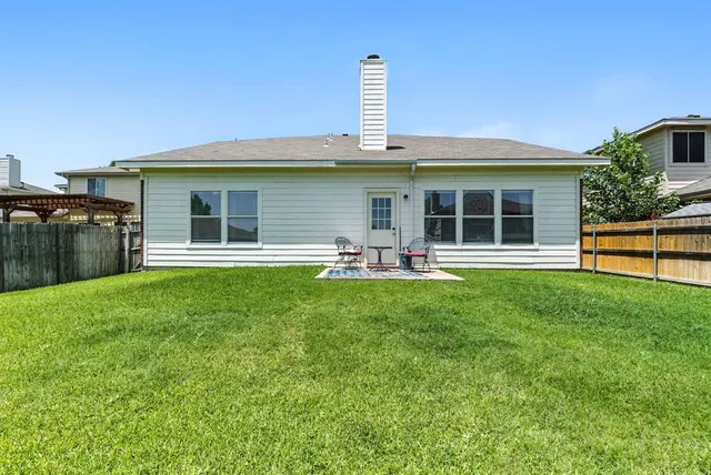 a front view of a house with a garden and yard