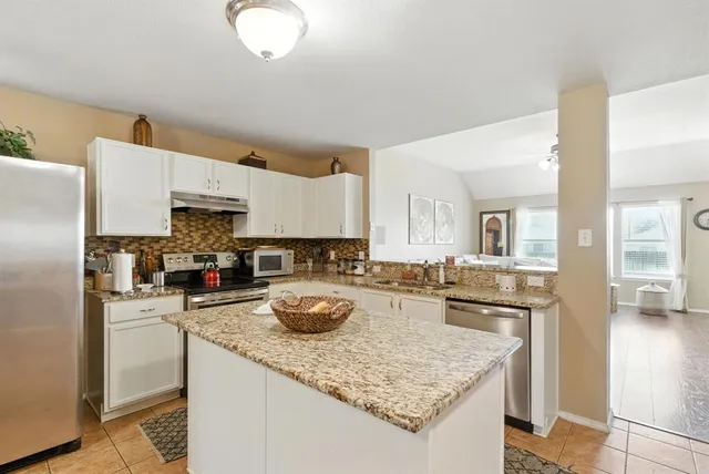 a kitchen with a sink a stove and refrigerator