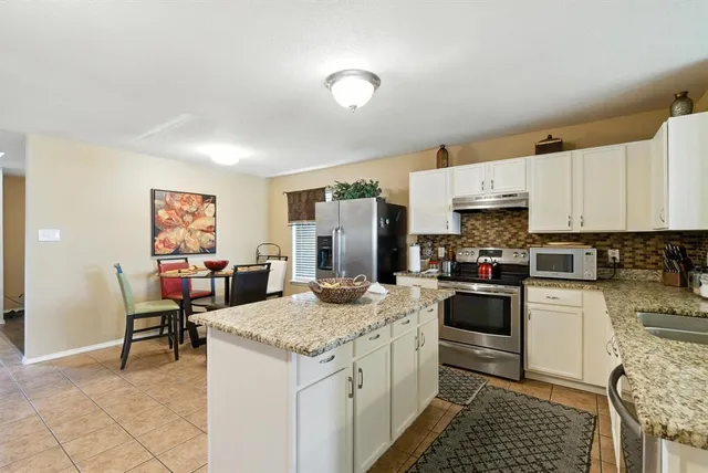 a kitchen with a sink stove and refrigerator