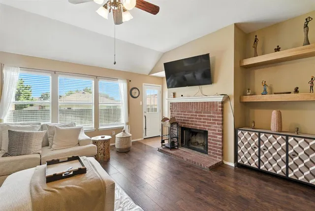 a living room with furniture fireplace and flat screen tv